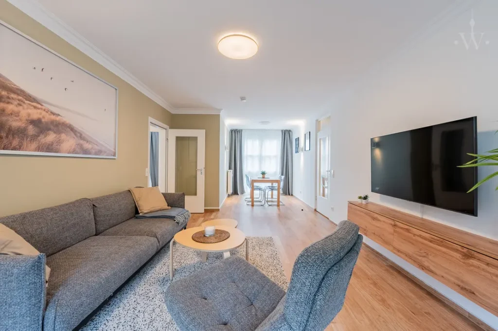 A sofa with a small coffee table and a television