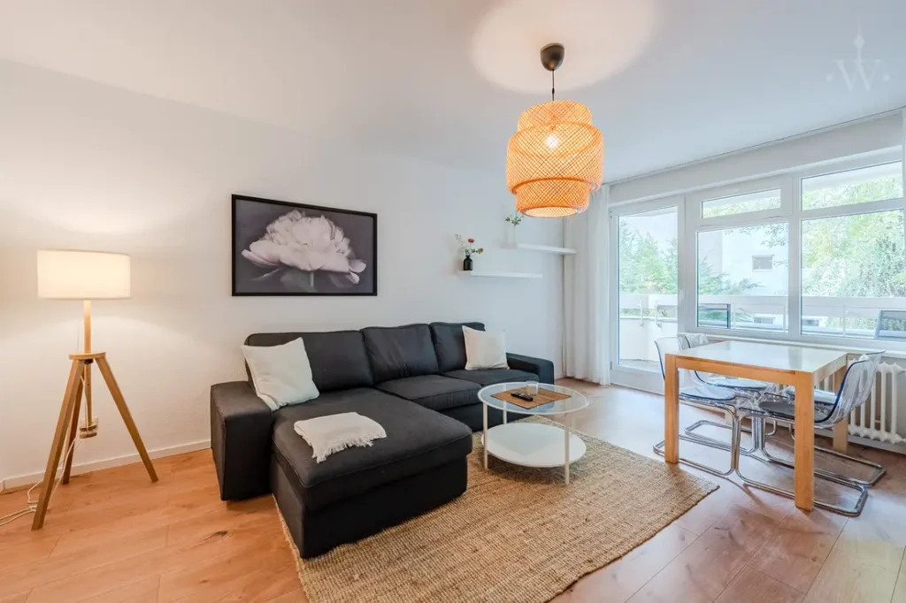 Sofa with a large window and a dining table